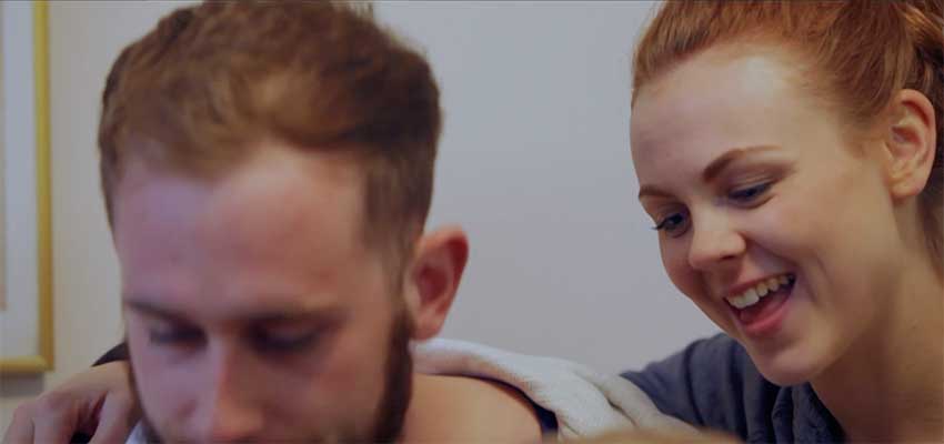 Happy young parents in a scene from a short fundraising film for Action for Children.